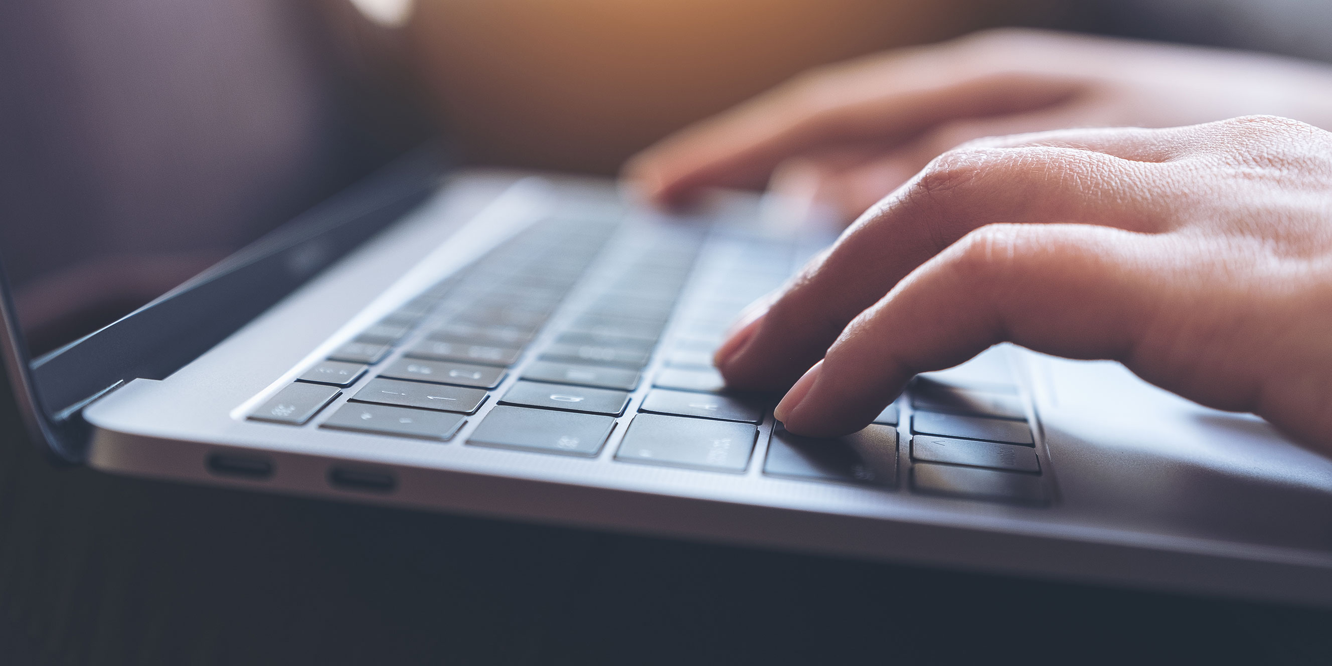 Closeup of hands typing on a keyboard while conducting application security training.